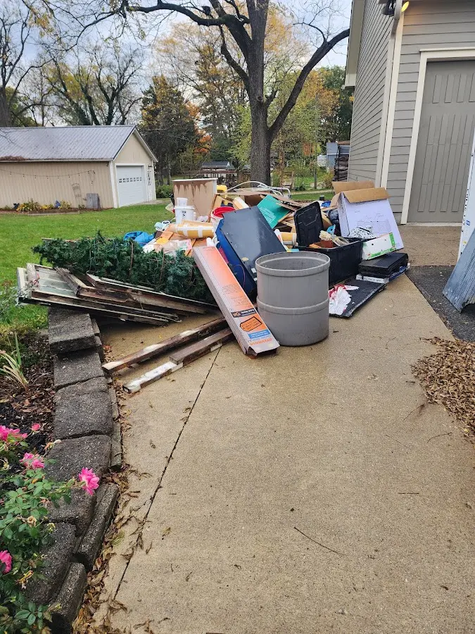 Dumpster being loaded with debris for Residential Dumpster Rental in Benton